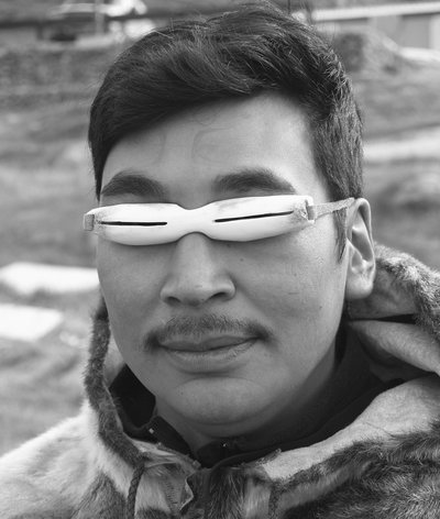 Inuit snow goggles made from caribou antler with caribou sinew for a strap